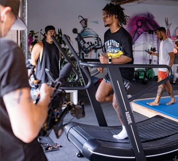 Elite MMA fighter training on the Aussie Pro Runner curved treadmill for fight conditioning
